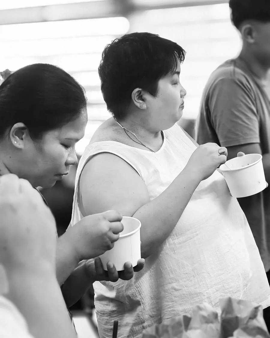 Choir members sharing food after rehearsal