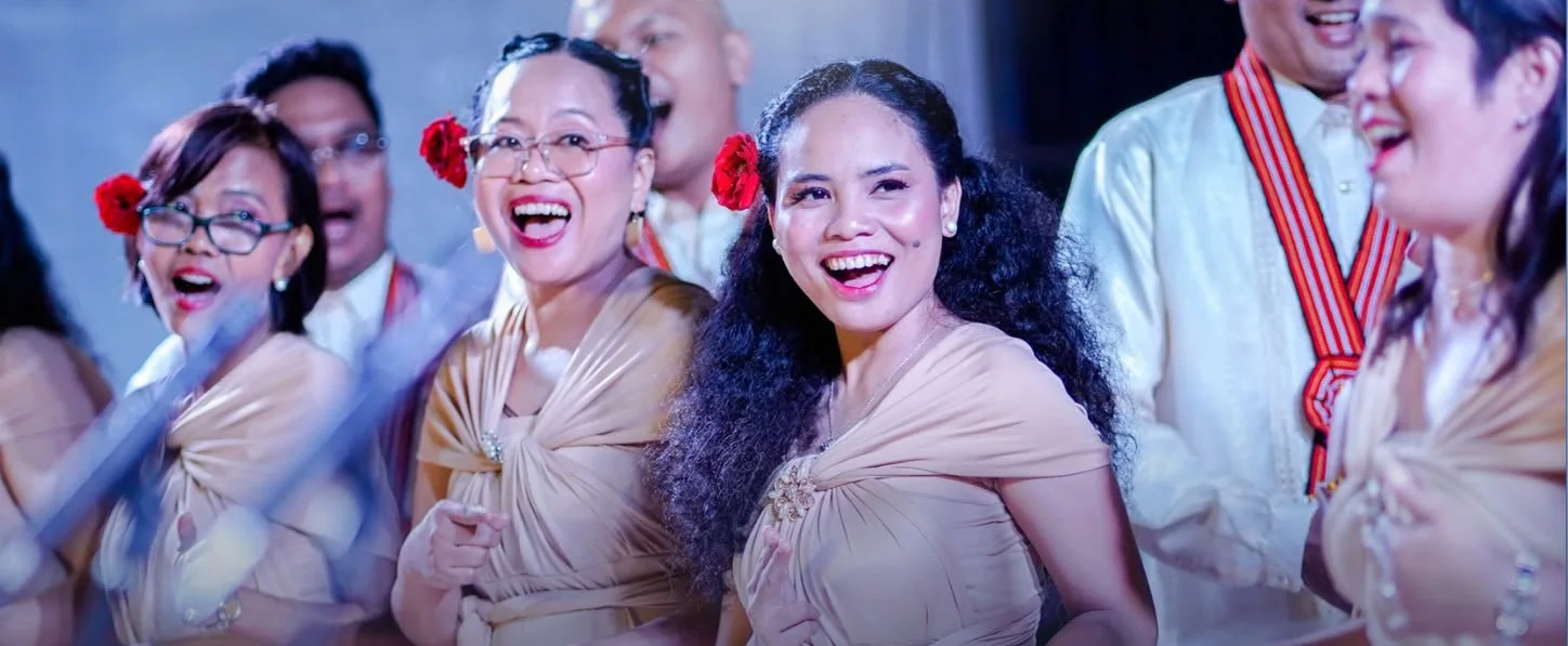 Choir members singing joyfully in performance
